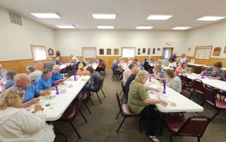 Community members enjoying their all-you-can-eat fish fry dinner