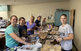 Volunteers make preparations for the 2024 Three Rivers Promise fish fry dinner