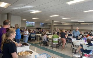 Members of the community enjoy a fish dinner supporting the Three Rivers Promise