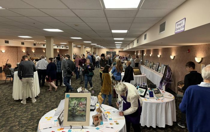 Attendees socialize and bid on the artwork from students and local artists